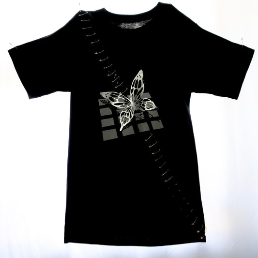 Punk-inspired black tee featuring butterfly graphic with safety pin embellishments.